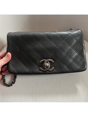 CHANEL Black Quilted Lambskin Shoulder Bag with Silver CC Lock.